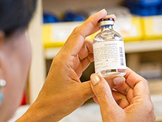 Pharmacist looking at vial