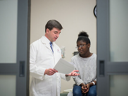 Dr. Greg Armstrong with a study participant