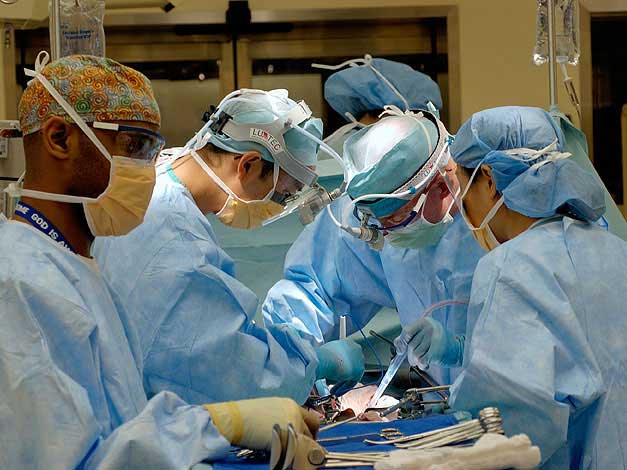 Several doctors and nurses performing surgery