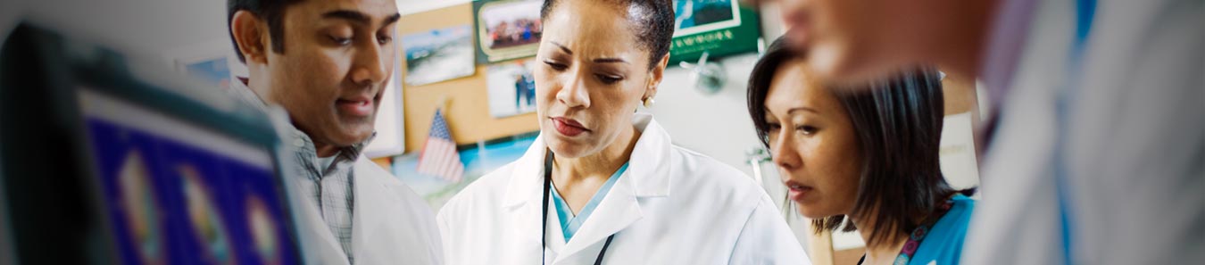 Doctors in lab coats collaborating