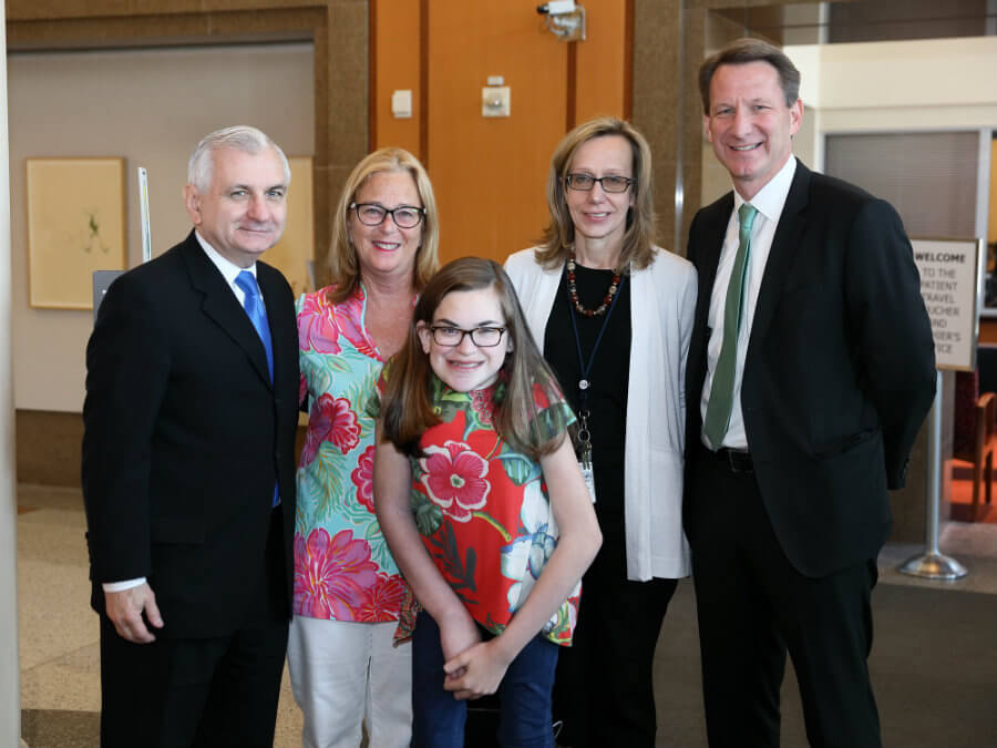 Photo of Senator Jack Reed, Candee and Lilly Ann Brooks, Brigitte Widemann, and Norman Sharpless, during the senator's May 1, 2018 visit with patients and staff of the NCI Pediatric Oncology Branch.