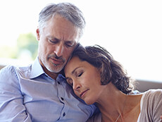 Woman leaning her head against a man's chest