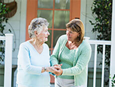 middle-aged woman helping mother