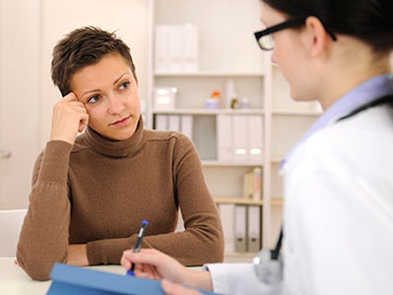 Anxious woman talking with her doctor