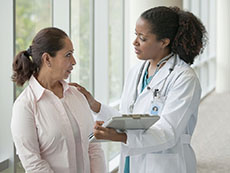 Female Doctor Comforting Female Patient