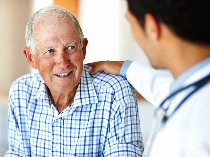 An Elder Man Smiling at a Male Doctor