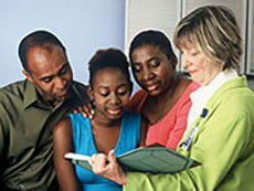 A teenager and her family visiting with her doctor.