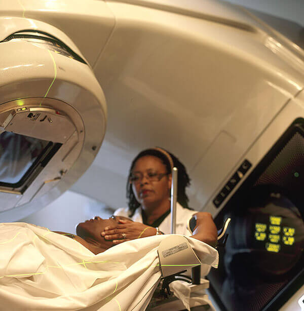 Nurse preparing a patient for radiation therapy