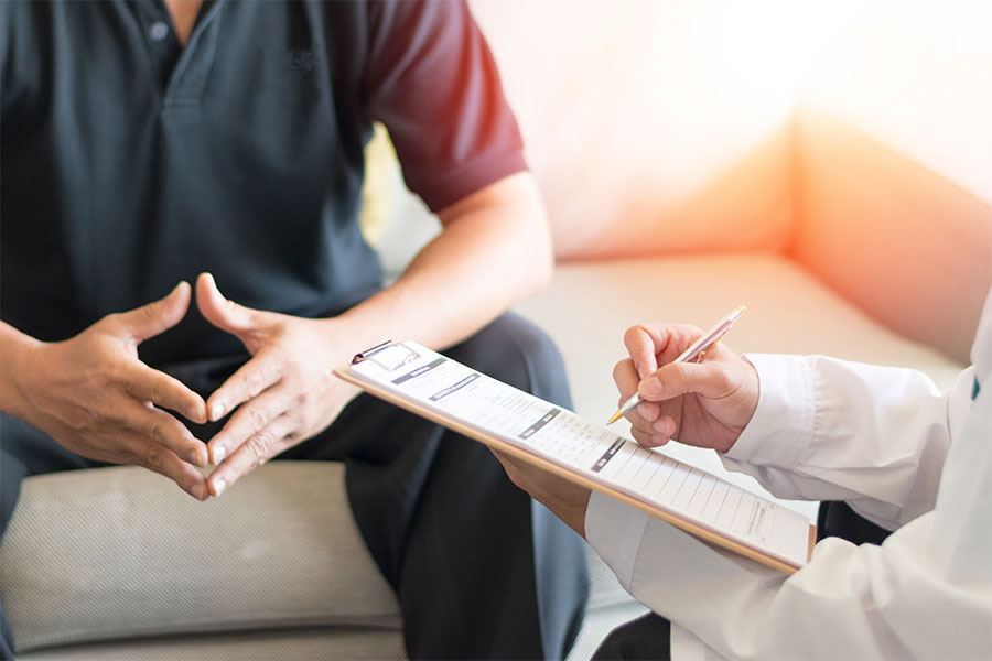 A physician consulting with a male patient.