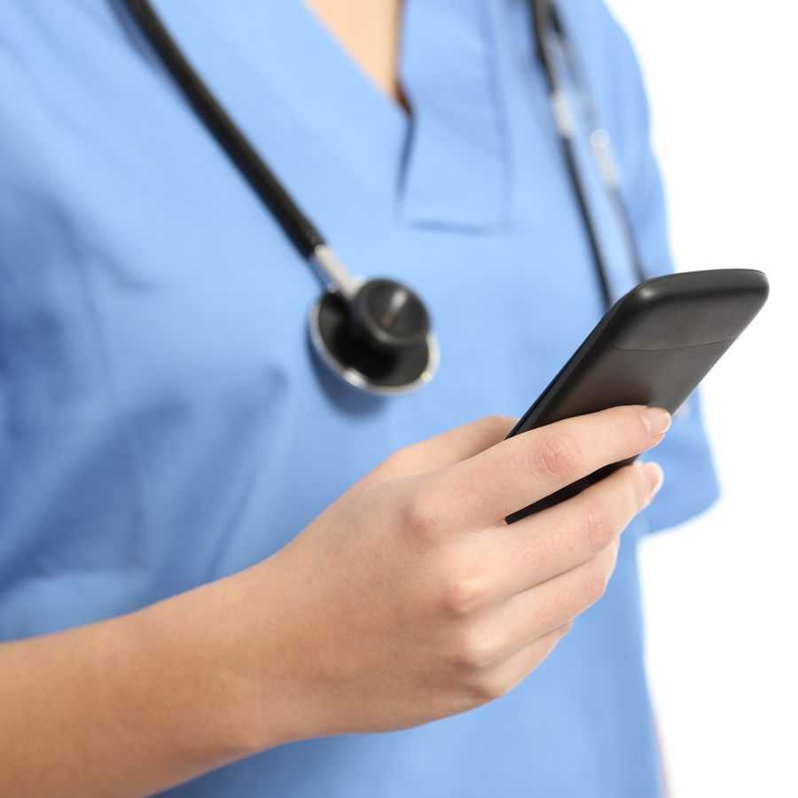 Health care provider looking at a smartphone