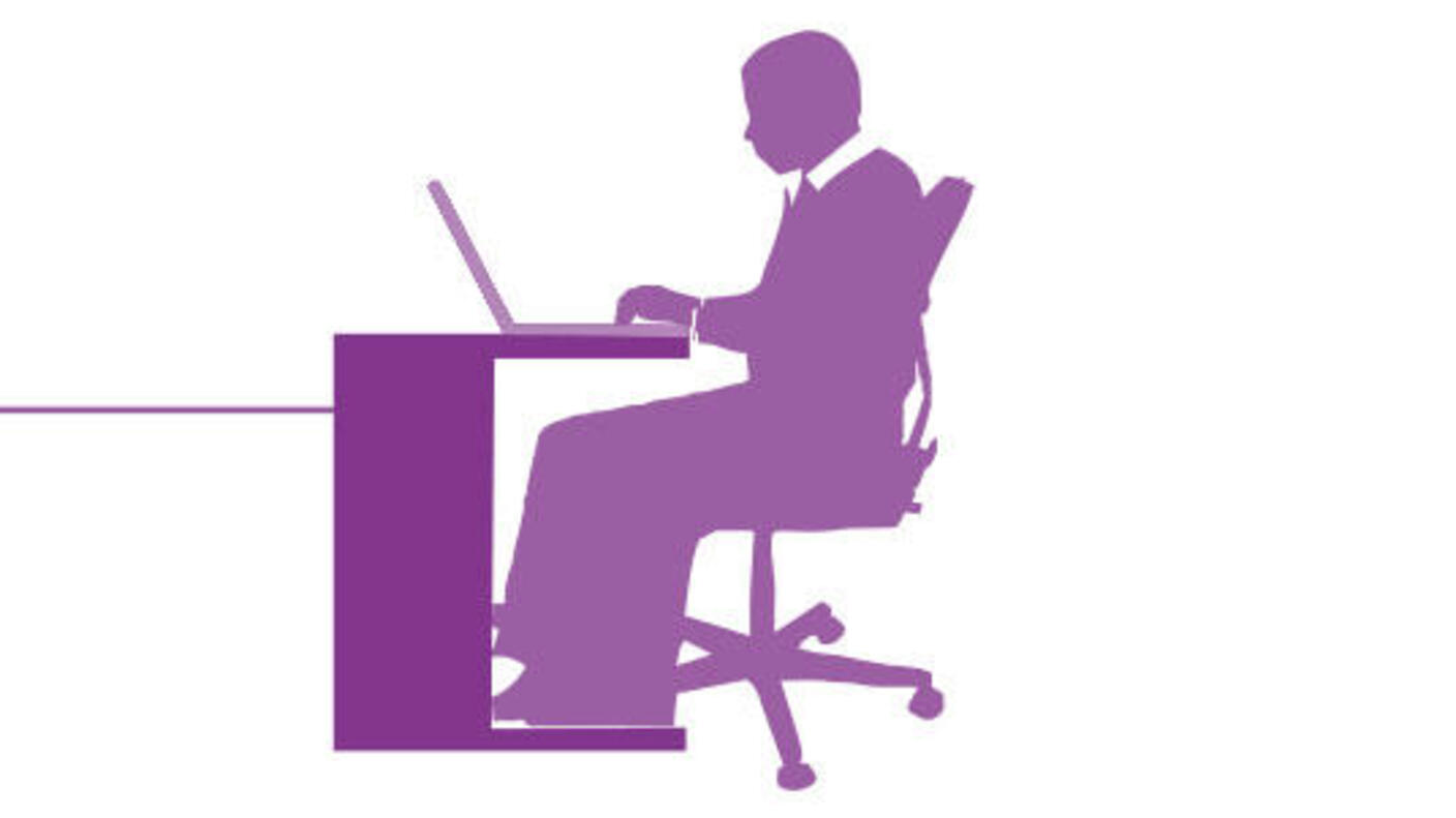 Image of person sitting at a desk using a laptop