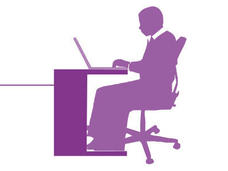 Image of person sitting at a desk using a laptop