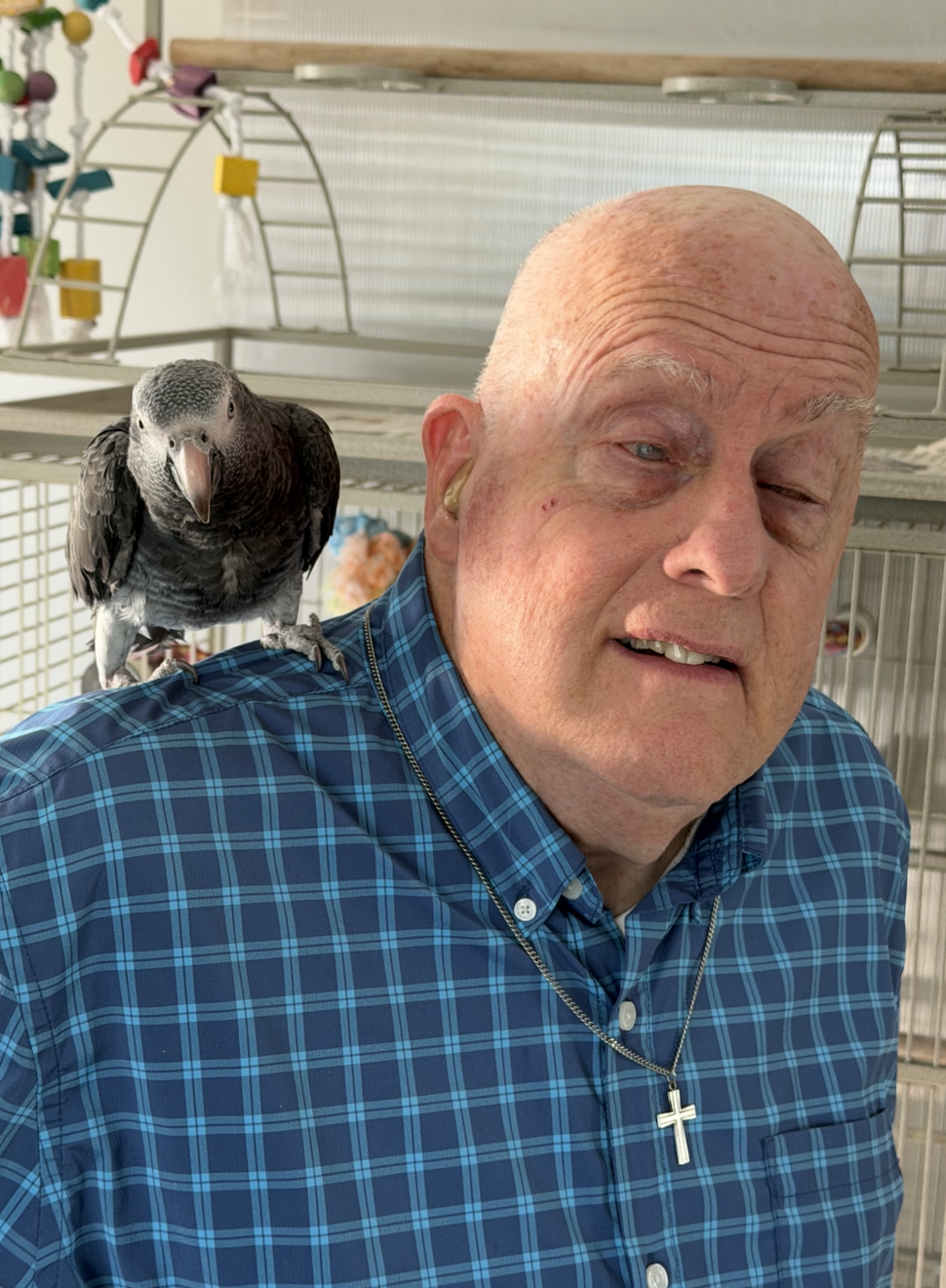 Connect participant, a man in a plaid shirt, with an African grey parrot perched on his shoulder.