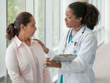 Female Doctor Comforting Female Patient