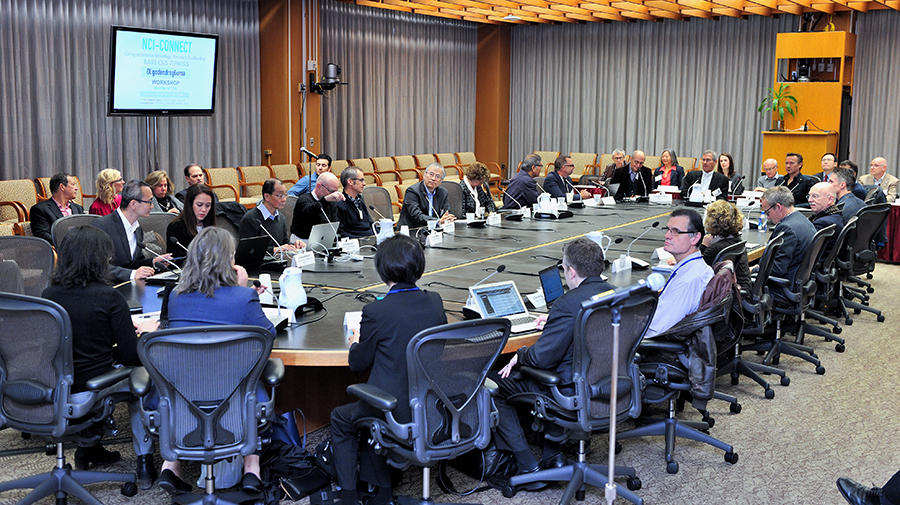 A large group of people seated around a conference table