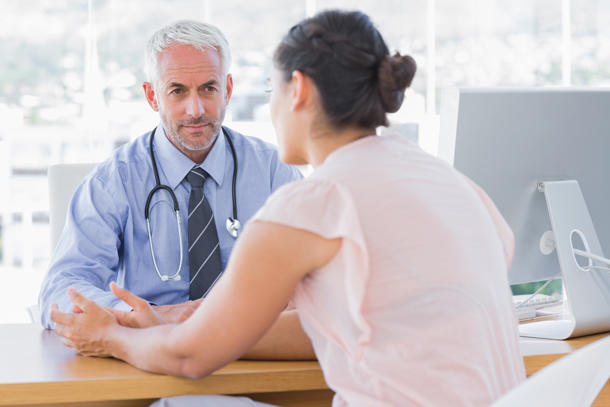 Patient speaking to doctor at a desk