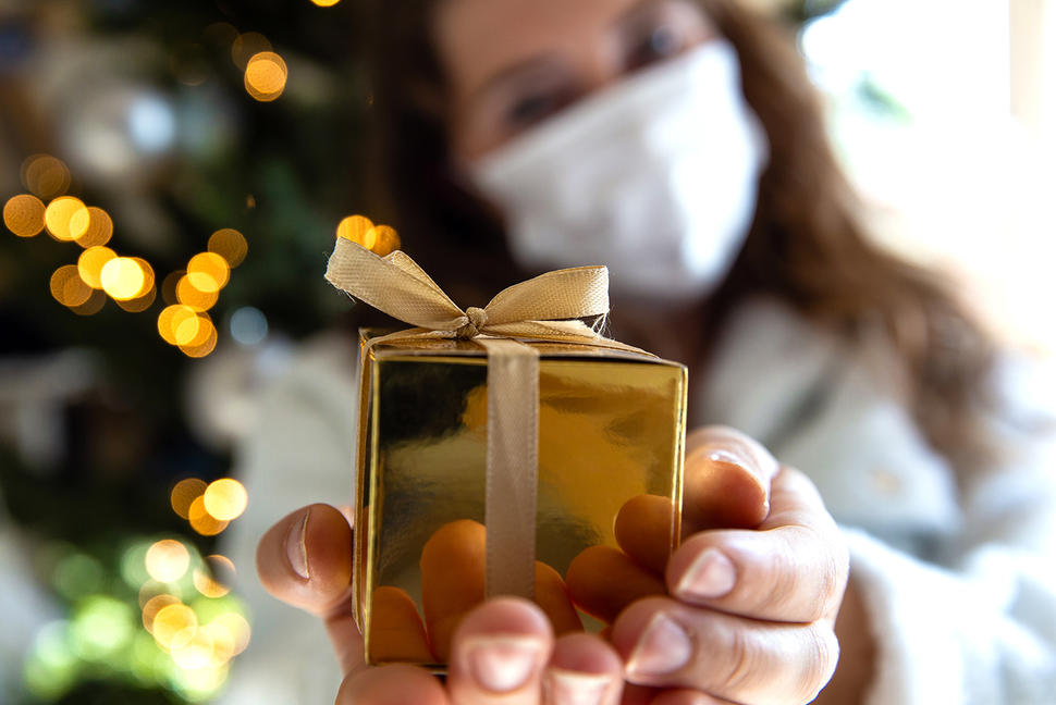 Girl with mask holding wrapped present