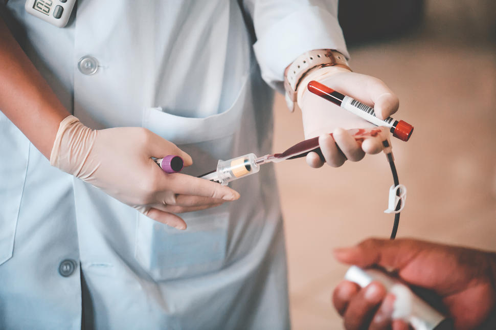 Nurse drawing a patient's blood