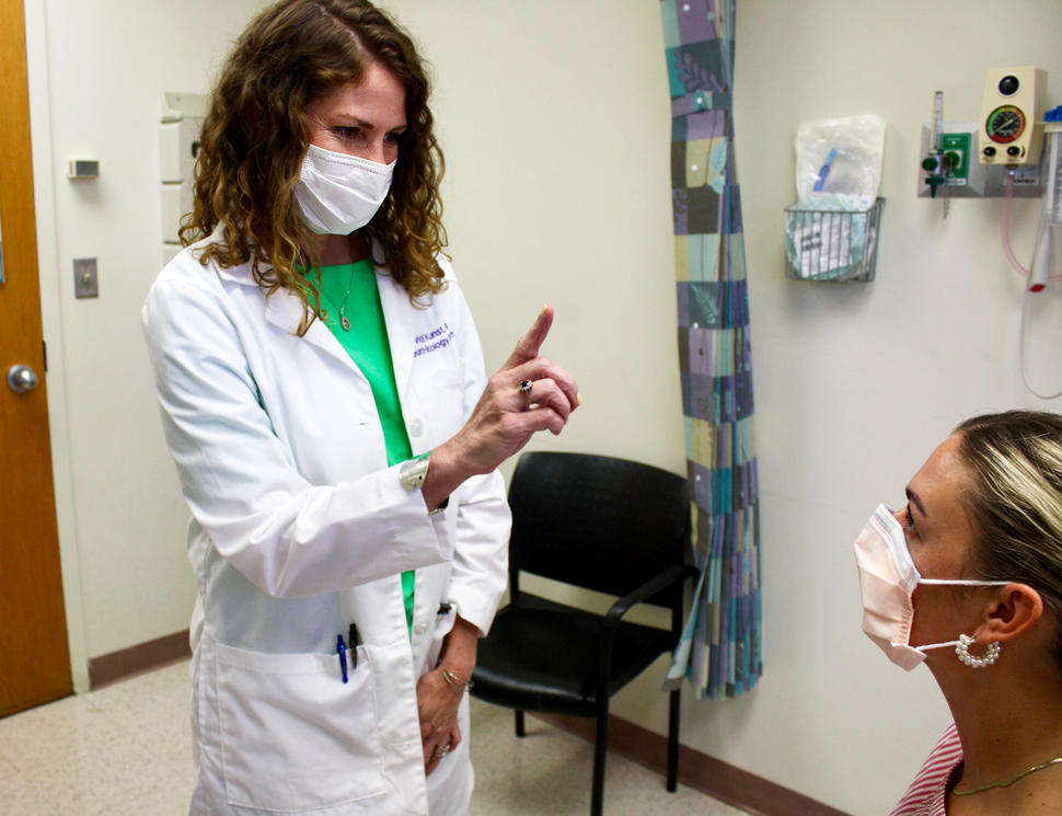 Tricia Kunst performing an exam on a patient at the neuro-oncology clinic