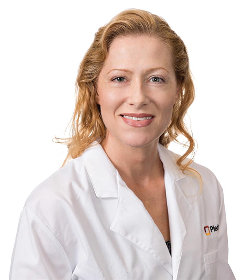 Headshot of Dr. Erin Dunbar in a white lab coat