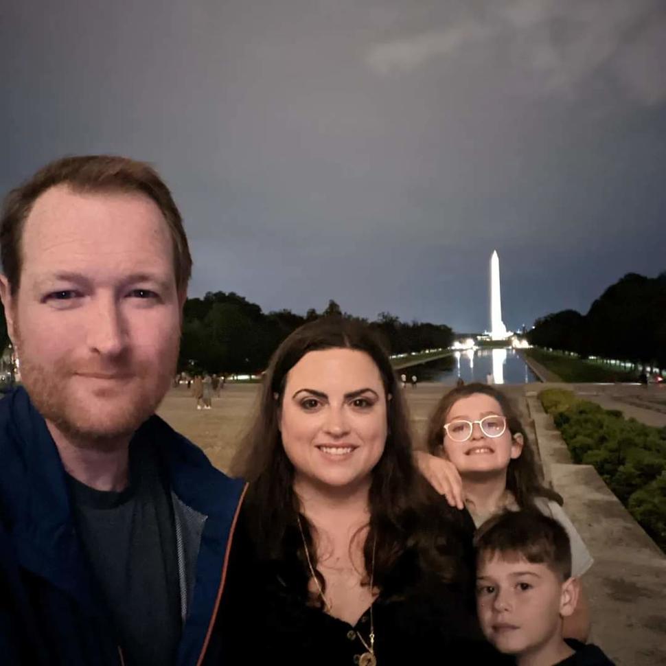Paul, his wife Stephanie, and his kids in front of the Washington Monument. 