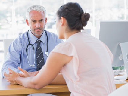 Patient speaking to doctor at a desk