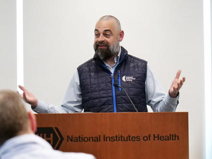 Adam Hayden speaking at a podium