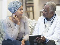 Cancer patient talking with her doctor