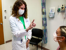 Tricia Kunst performing an exam on a patient at the neuro-oncology clinic