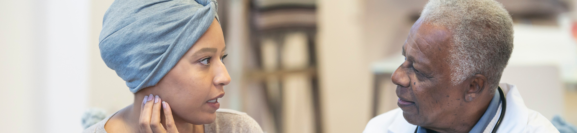 A female patient talking to a male doctor.