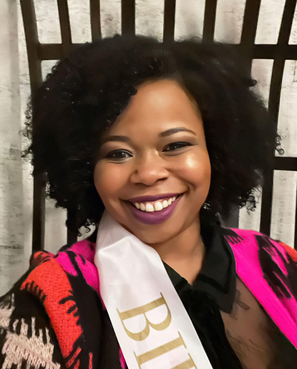 Donita smiling and wearing a birthday sash