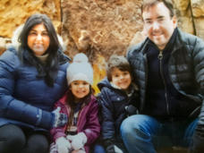 Tom sitting with his wife and two children