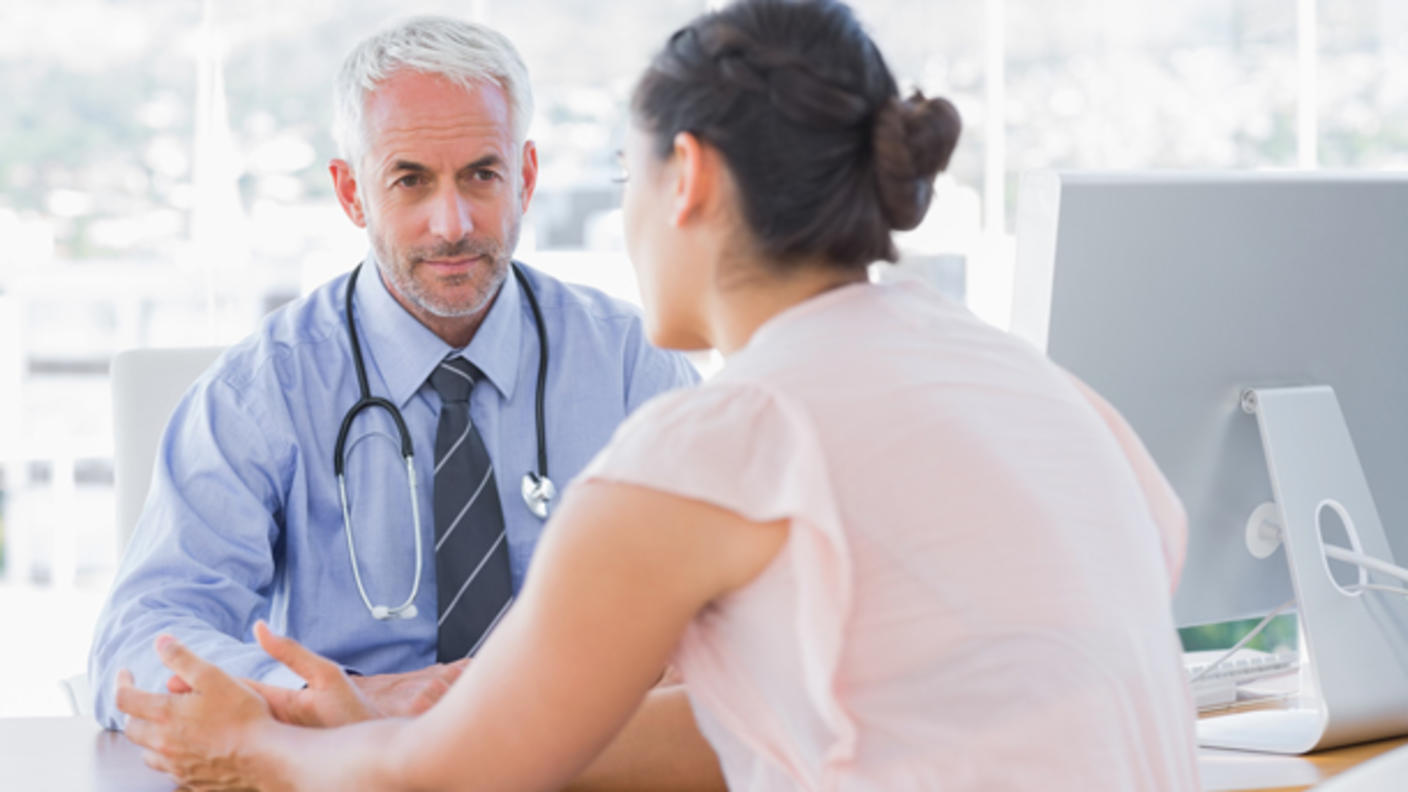 Patient speaking to doctor at a desk