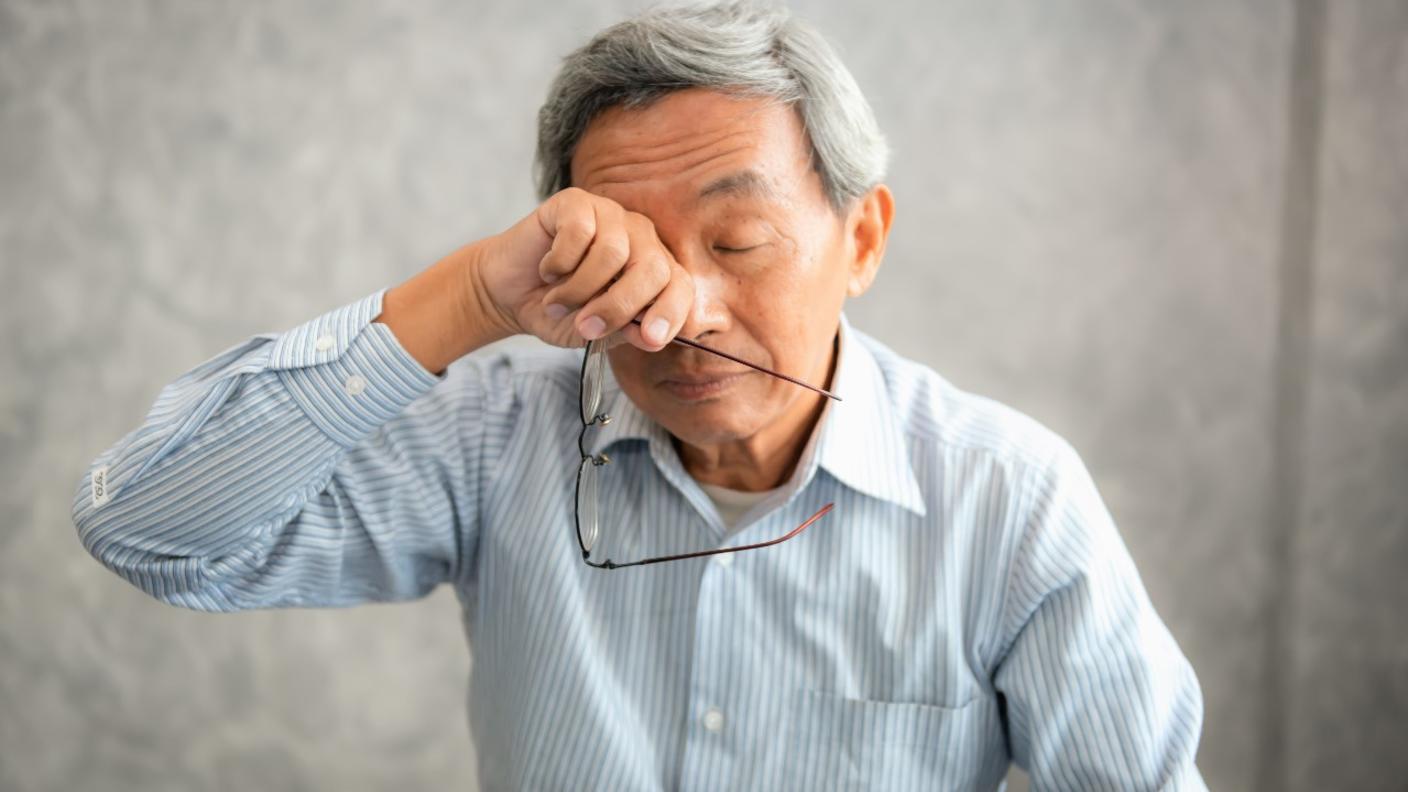 Man rubbing his tired eyes