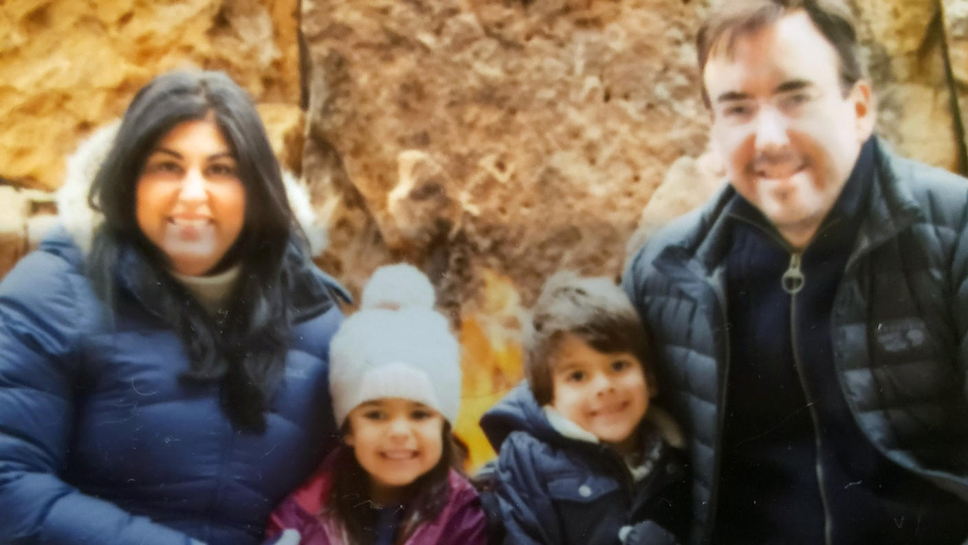 Tom sitting with his wife and two children