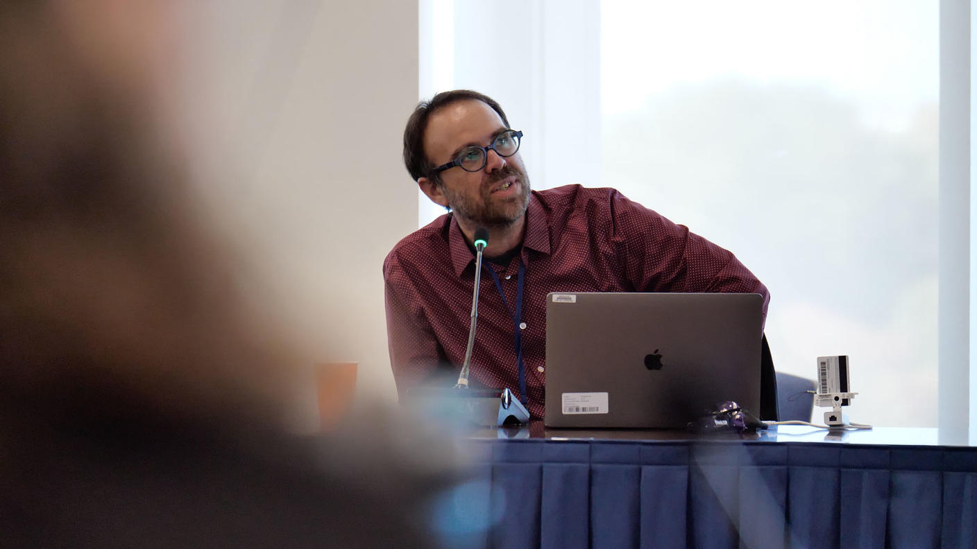 Byram Ozer talking into microphone