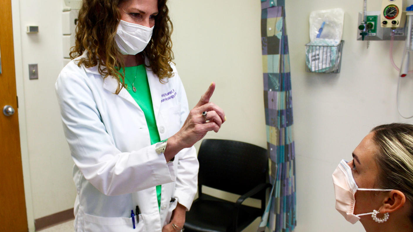 Tricia Kunst performing an exam on a patient at the neuro-oncology clinic