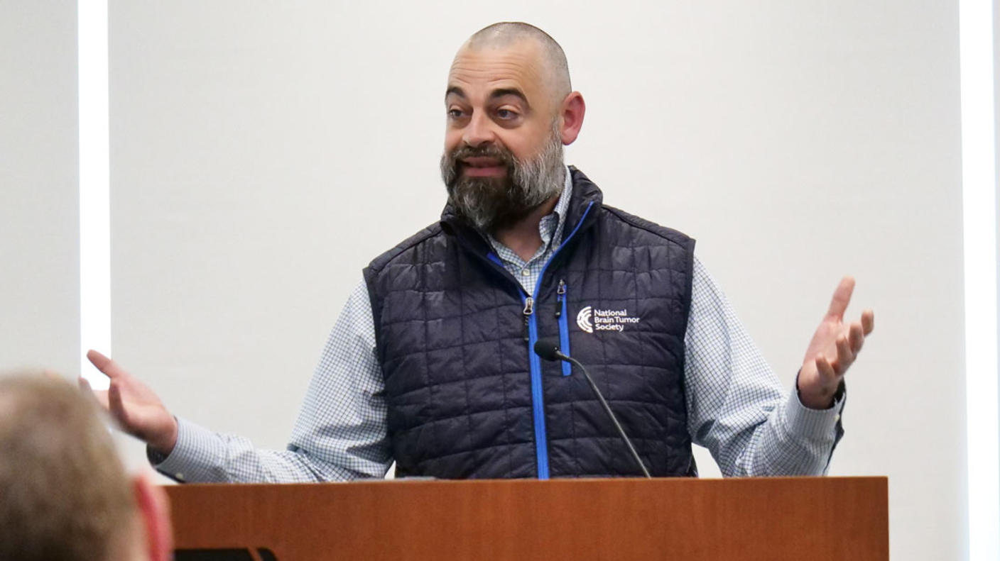 Adam Hayden speaking at a podium