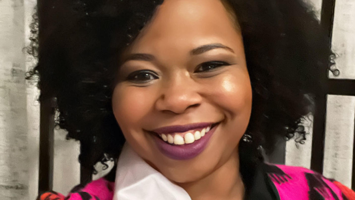 Donita smiling and wearing a birthday sash