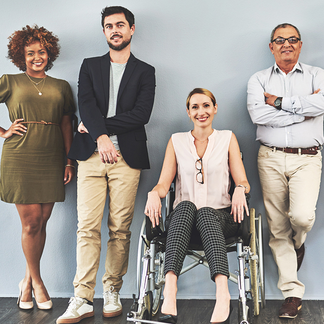 Diverse group of people standing against a wall