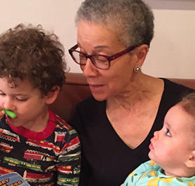 Headshot of Adine Usher with two grandchildren