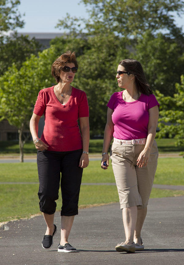 Woman with cancer and her friend taking a walk together. 