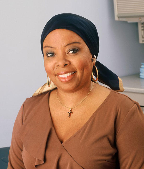 Woman with hair loss wearing a fashionable scarf to cover her head. 