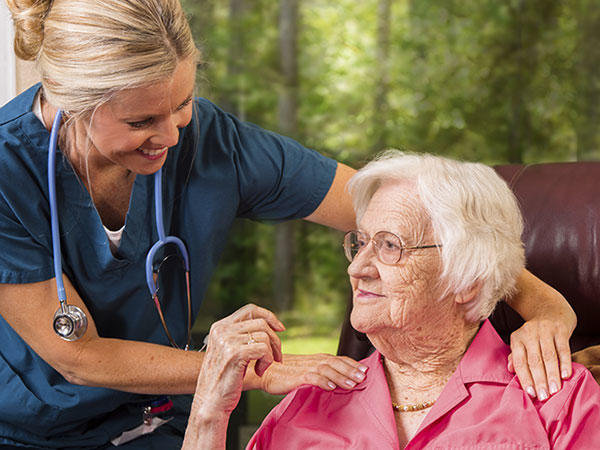 Woman receiving advice from her helpful and smiling nurse.  