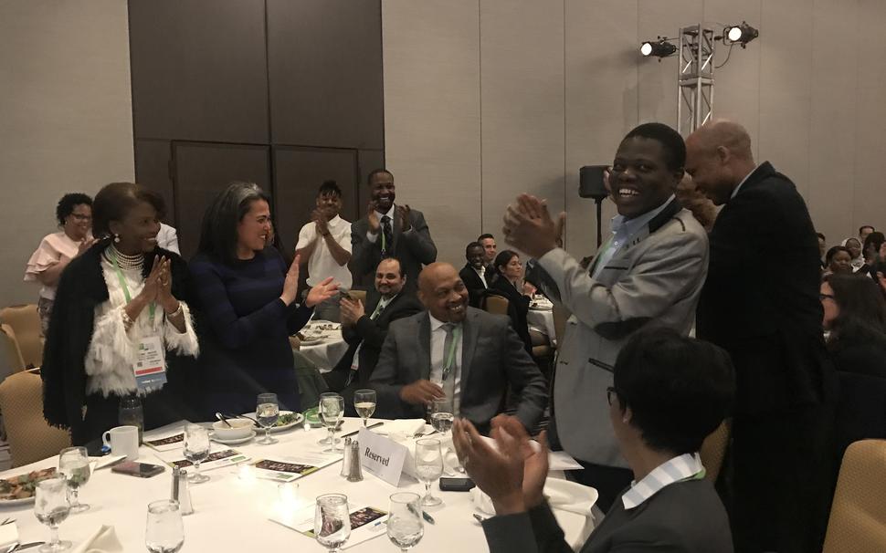 The audience applauds as Dr. John Carpten is recognized for serving as the first African American Program Chair of the AACR Annual Meeting.