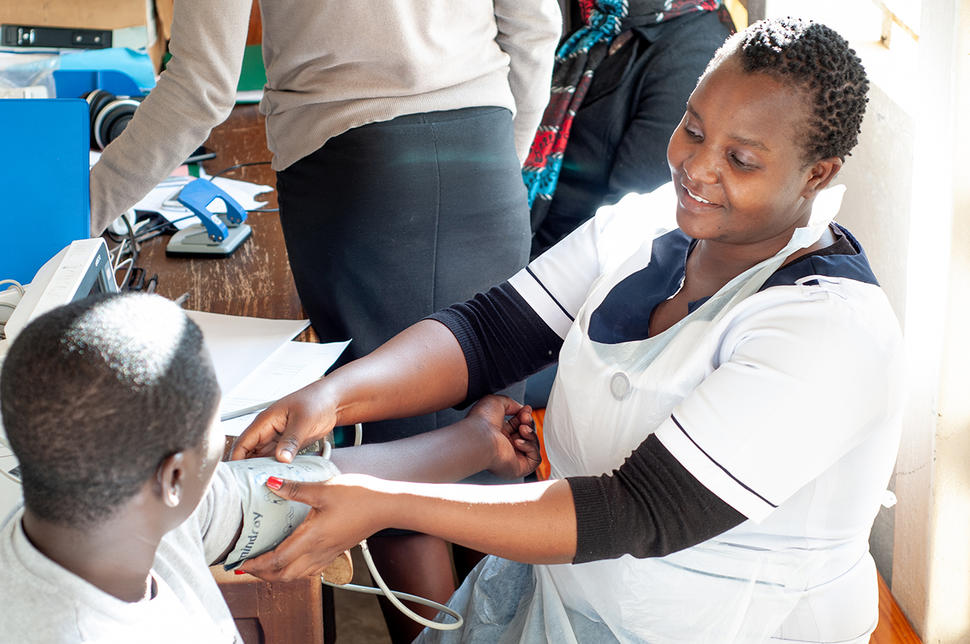 A nurse with a patient at Kamuzu Central Hospital in Malawi