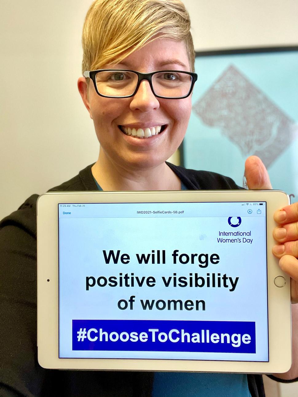 Kalina Duncan, MPH, DrPH (c) poses with sign "we will forge positive visibility in women" for International Women's Day 2021