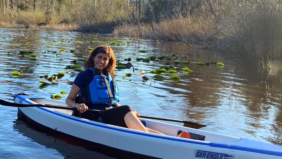 Woman in a lifejacket kayaking