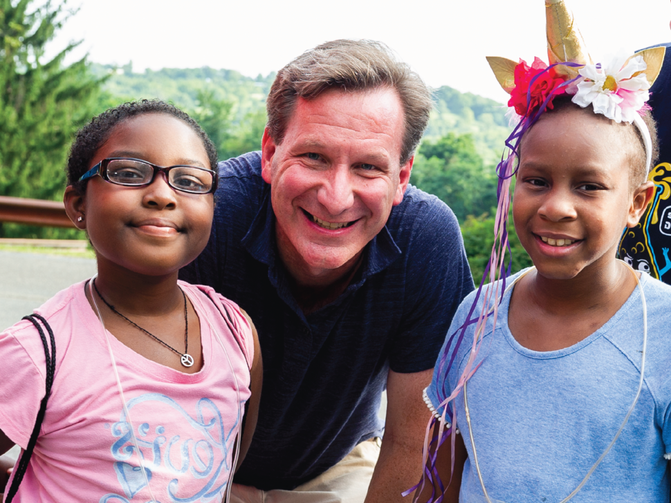 NCI Director Dr. Norman E. Sharpless with two campers