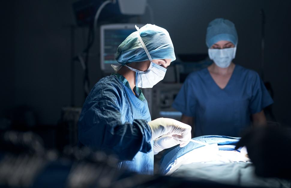 A woman surgeon performing surgery in an operating room